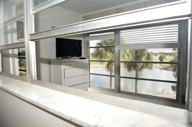 a living room with a flat screen tv and a large window