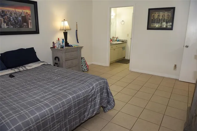 a bedroom with a bed and cabinets