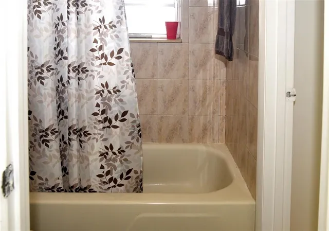 a bathroom with a bathtub and shower