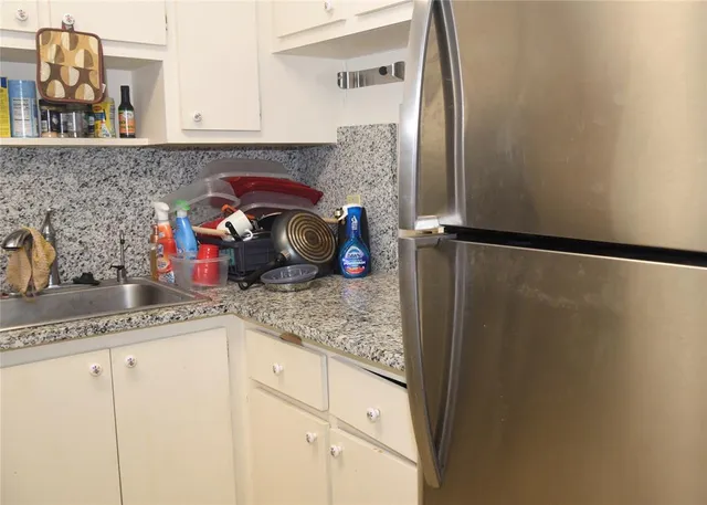 a kitchen with a refrigerator and sink
