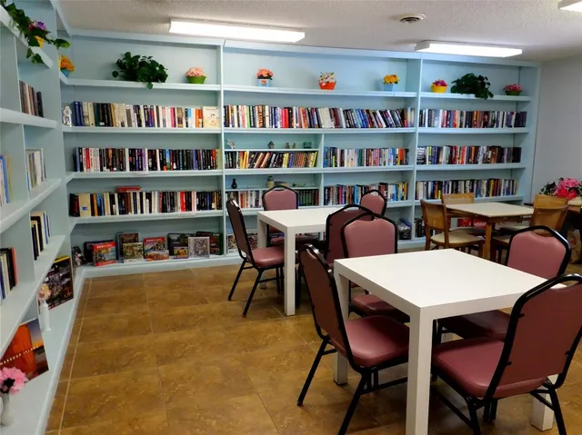 a view of a dining room with furniture and a bookshelf