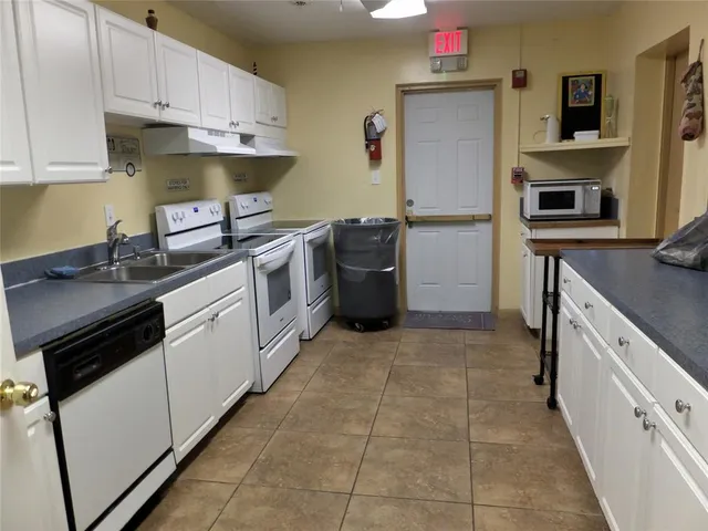 a kitchen with a sink stove and refrigerator