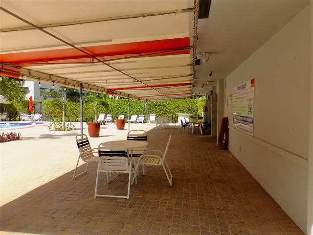 a patio with a table and chairs