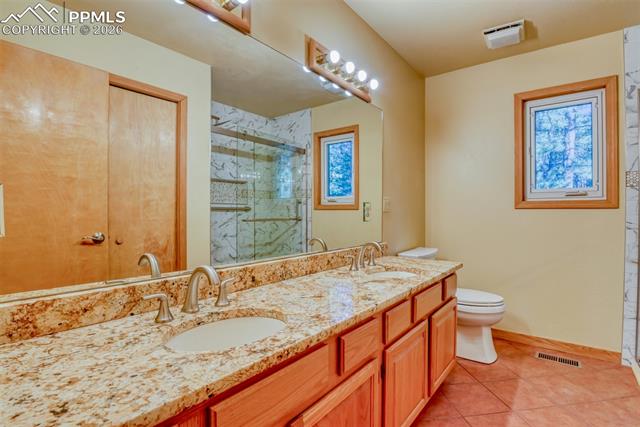 16111 Roller Coaster Road Colorado Springs, CO 80921 - Photo 16 of 26 Main-level bathroom with newly remodeled shower with barn doors