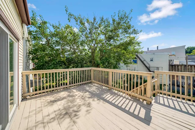 a view of balcony with wooden floor and fence