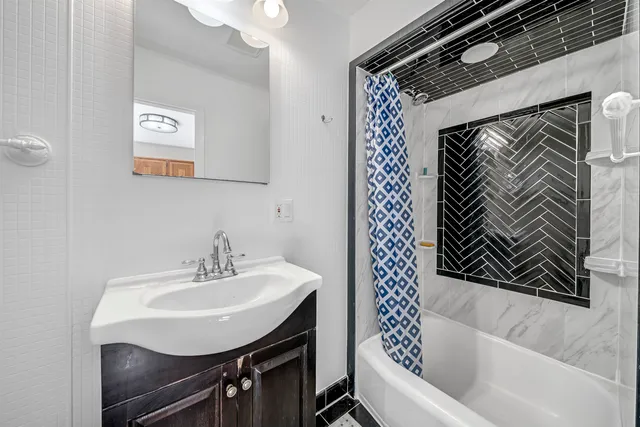 a bathroom with a sink a toilet and mirror