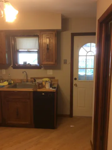 a kitchen with granite countertop stainless steel appliances and wooden cabinets