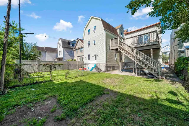a view of a brick building next to a yard