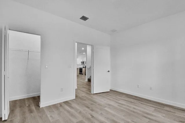 a view of an empty room and wooden floor
