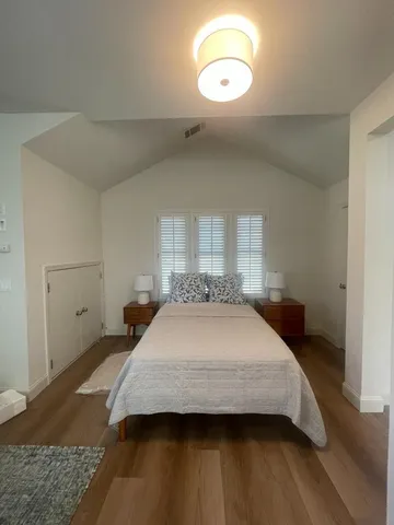 a bedroom with a bed and window