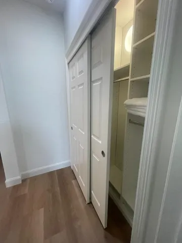 a view of hallway with wooden floor