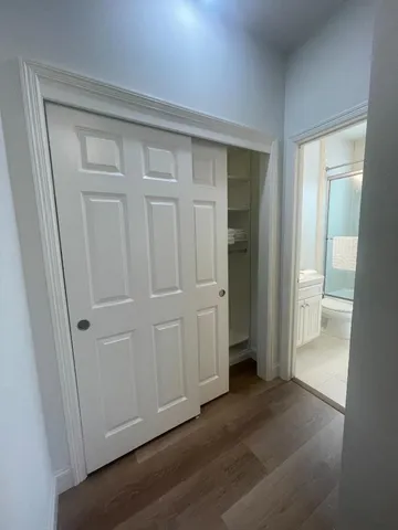 a view of an empty room and wooden floor