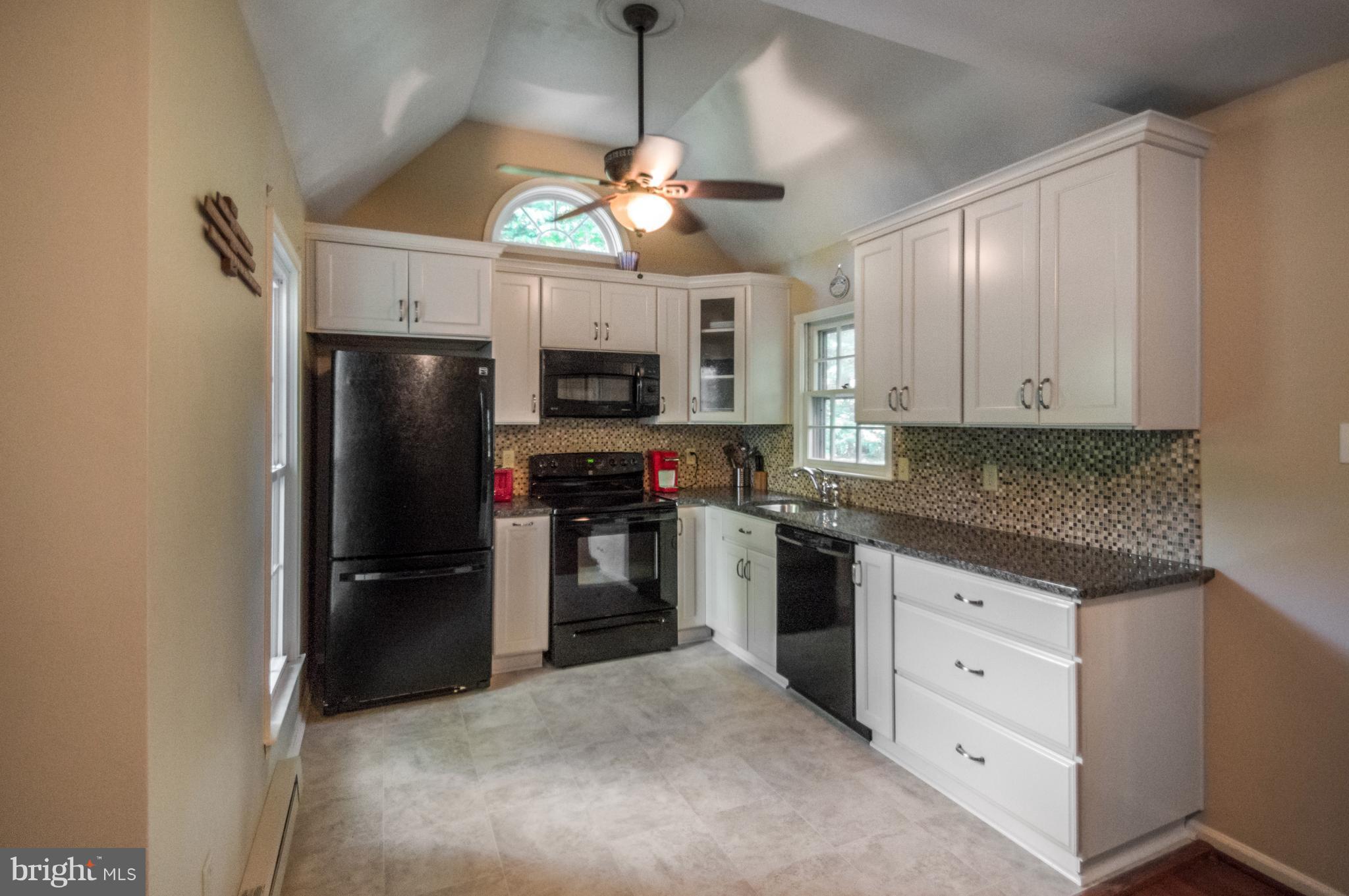 3812 Pippins Place Point of Rocks, MD 21777 - Photo 5 of 19 a kitchen with kitchen island granite countertop stainless steel appliances a stove refrigerator a microwave oven cabinets and a refrigerator