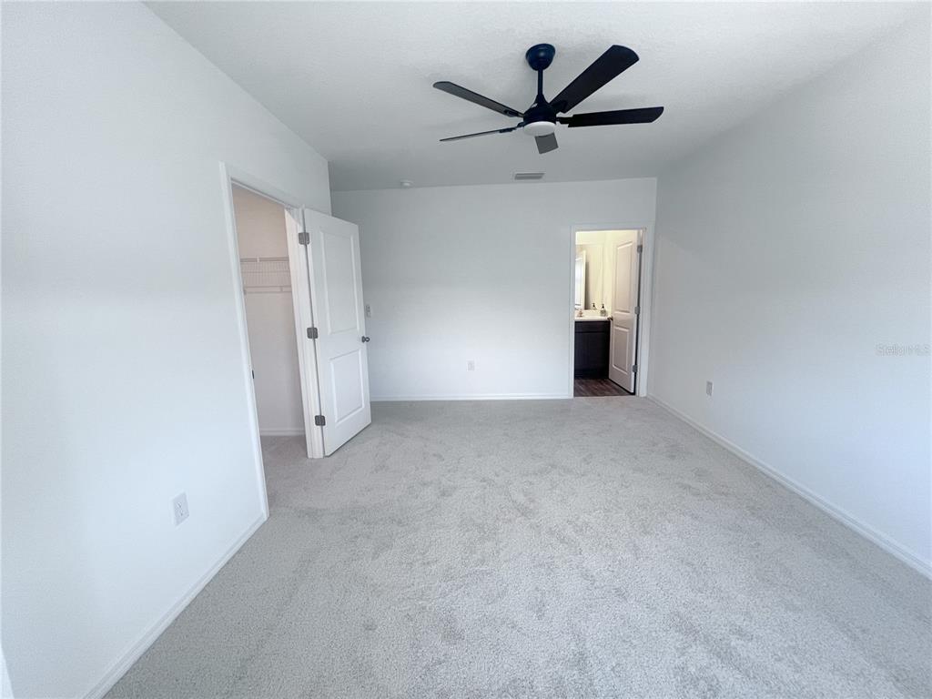 2476 Riversong Ldg Lane Wesley Chapel, FL 33543 - Photo 16 of 22 an empty room with closet and windows