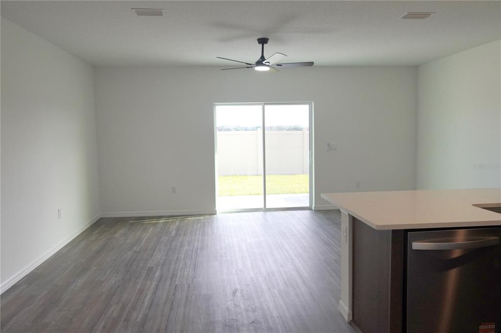 2476 Riversong Ldg Lane Wesley Chapel, FL 33543 - Photo 3 of 22 wooden floor in an empty room with a window