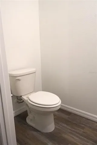 a white toilet sitting next to a white sink