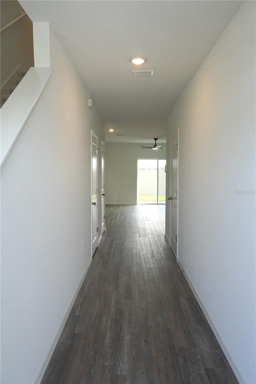 2476 Riversong Ldg Lane Wesley Chapel, FL 33543 - Photo 6 of 22 a view of wooden floor and windows in an empty room