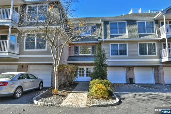 a front view of a residential apartment building with a yard