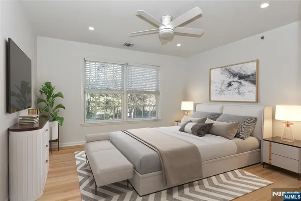 a bedroom with a large bed and a window