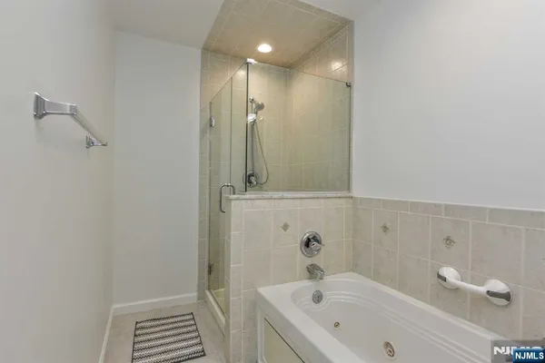 a bathroom with a tub and shower
