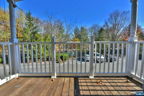 a view of a balcony with wooden floor and fence