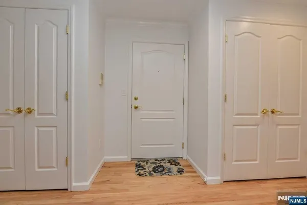 a view of a closet area with hardwood floor