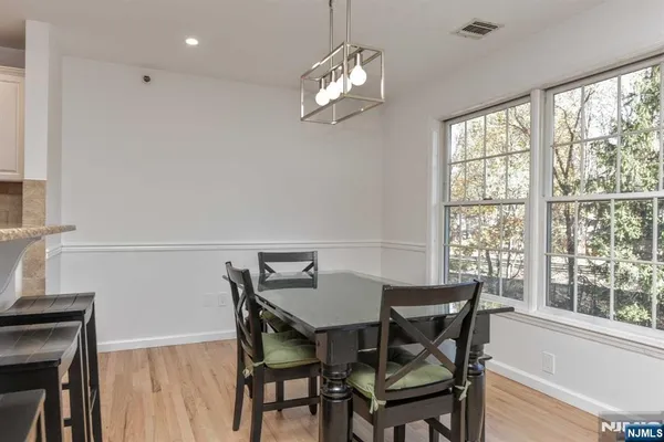 a view of a dining room with furniture and a chandelier