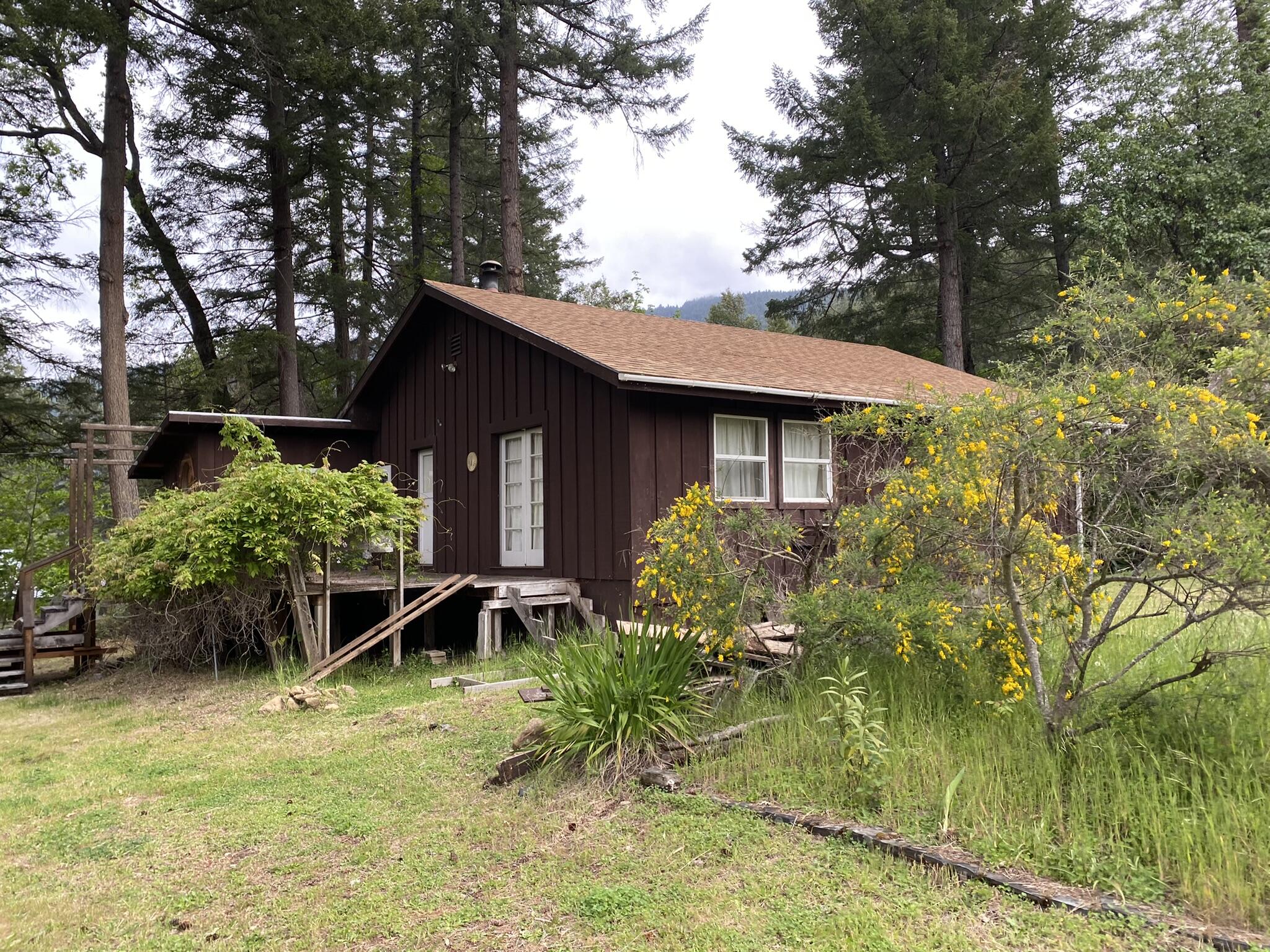 465 China Flat Road Burnt Ranch, CA 95527 - Photo 1 of 1 a front view of a house with garden
