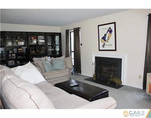 401 Maplecrest Road Edison, NJ 08820 - Photo 3 of 20 a living room with furniture a fireplace and a large window