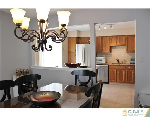 401 Maplecrest Road Edison, NJ 08820 - Photo 8 of 20 a kitchen with a table and chairs