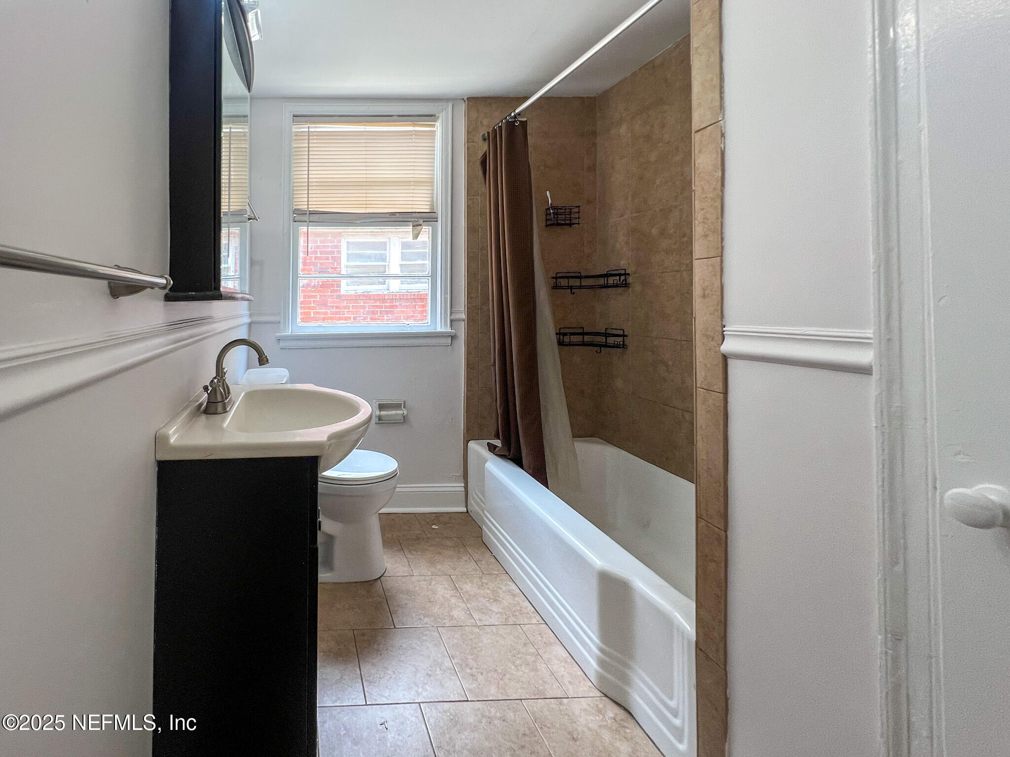 2575 Myra Street, Unit 2 Jacksonville, FL 32204 - Photo 12 of 18 a bathroom with a sink a toilet and shower