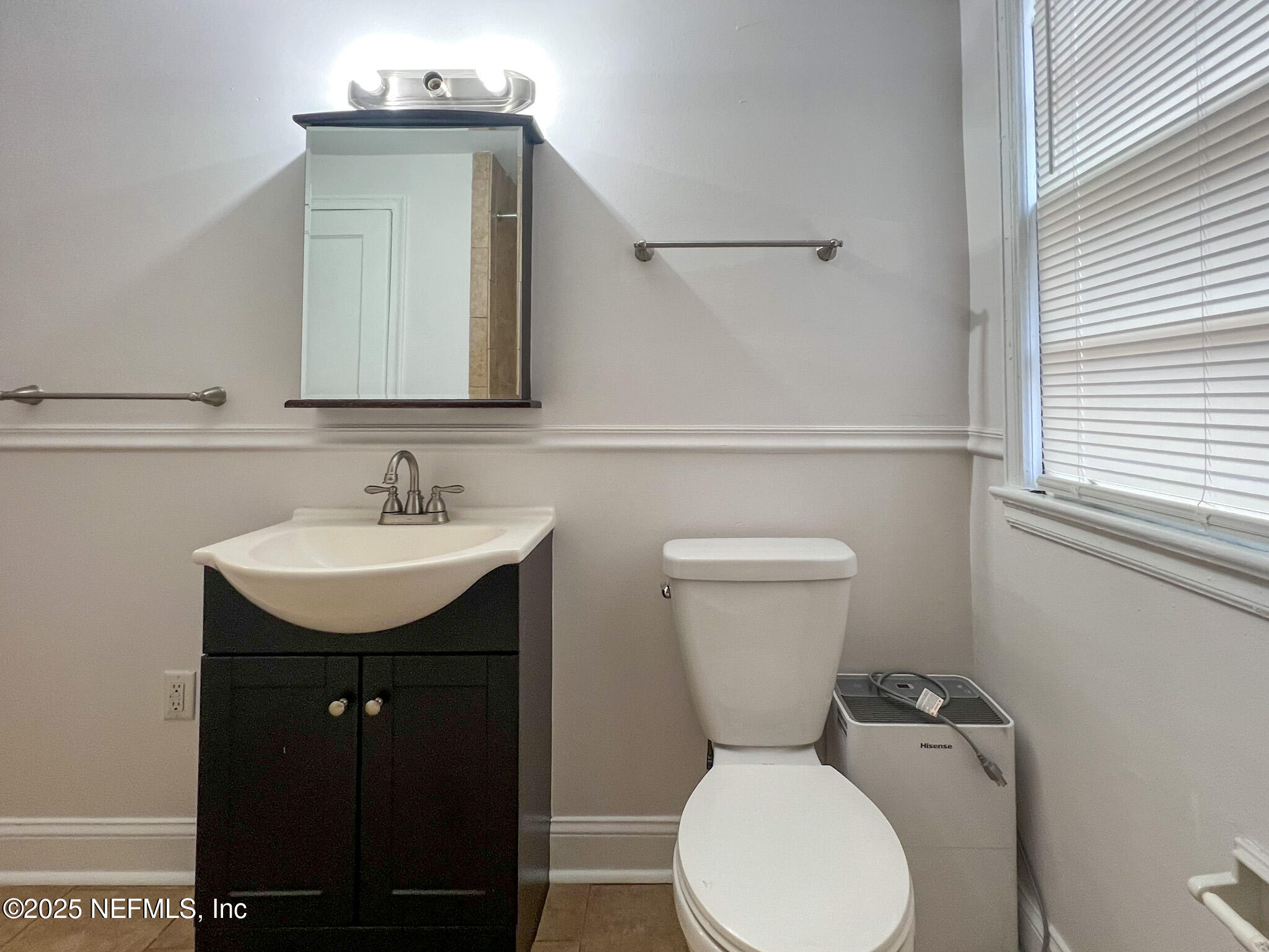 2575 Myra Street, Unit 2 Jacksonville, FL 32204 - Photo 13 of 18 a bathroom with a toilet sink and mirror