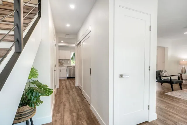 a view of a hallway view with wooden floor and staircase