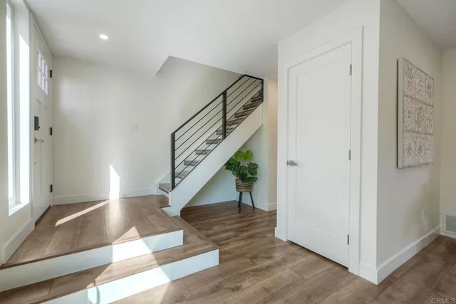 a view of entryway and hall with wooden floor
