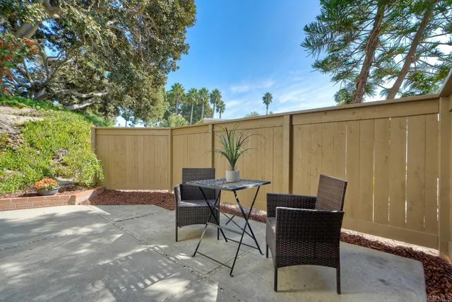 a view of a patio with table and chairs and potted plants