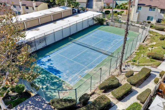 a view of a patio with table and chairs potted plants
