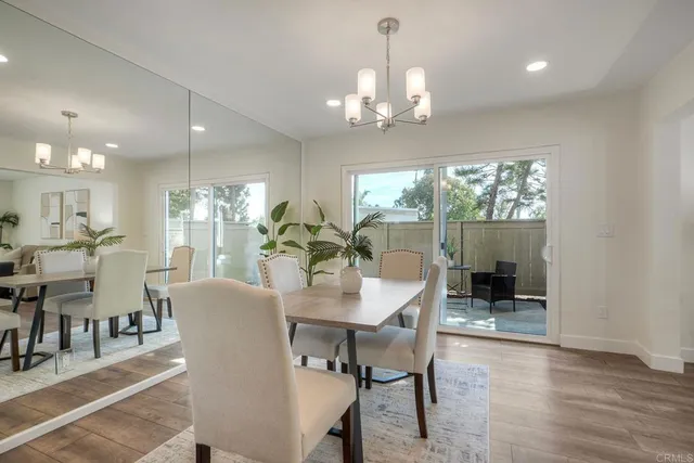 a view of a dining room with furniture wooden floor and chandelier