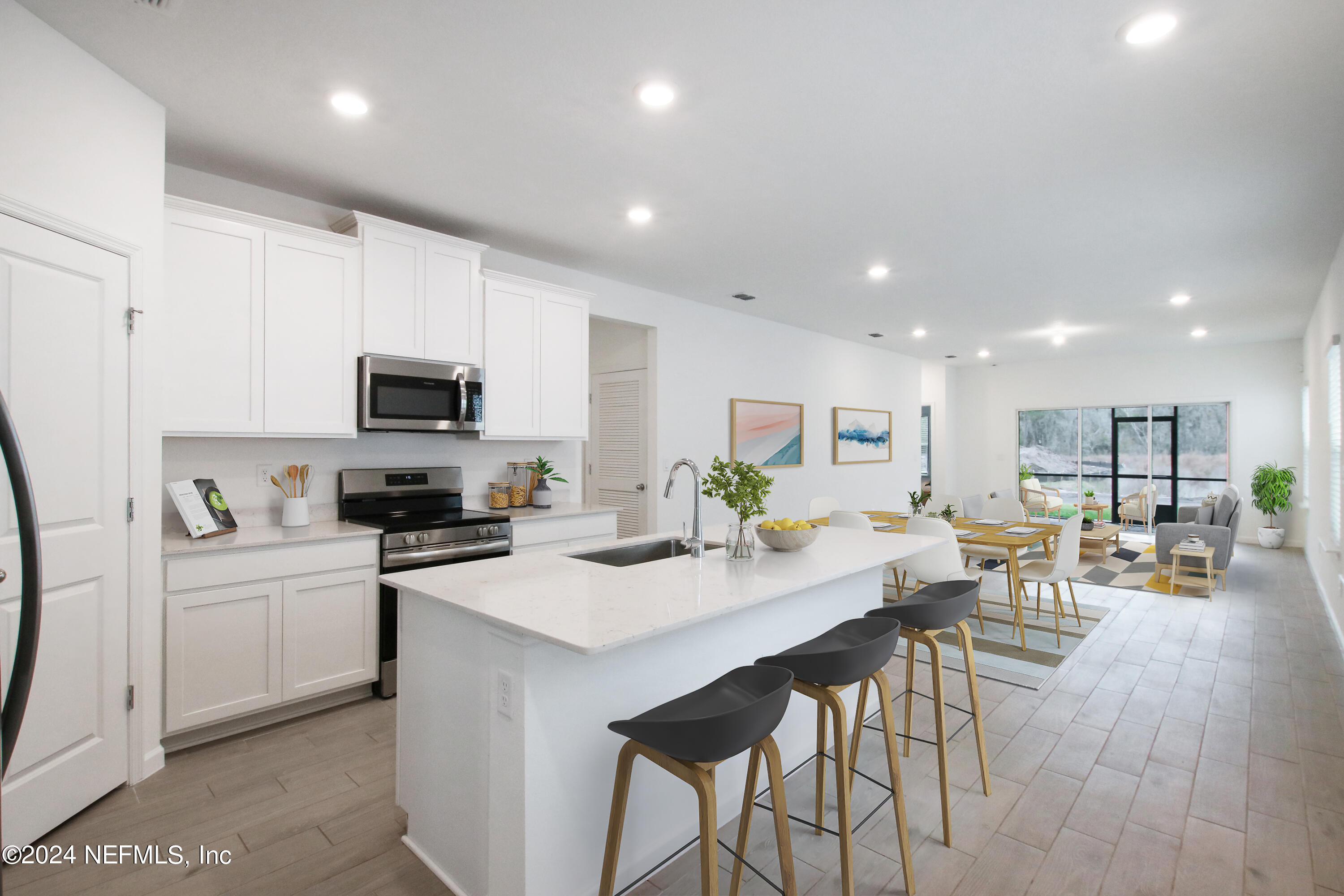 168 Pentwater Road St. Augustine, FL 32092 - Photo 2 of 13 a kitchen with a table chairs microwave and cabinets