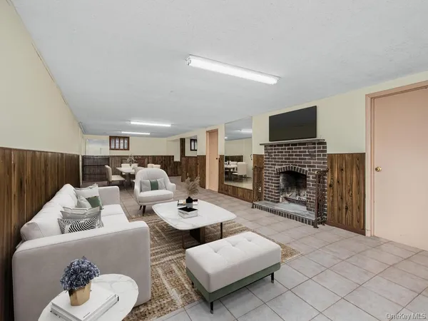 a living room with furniture a fireplace and a flat screen tv