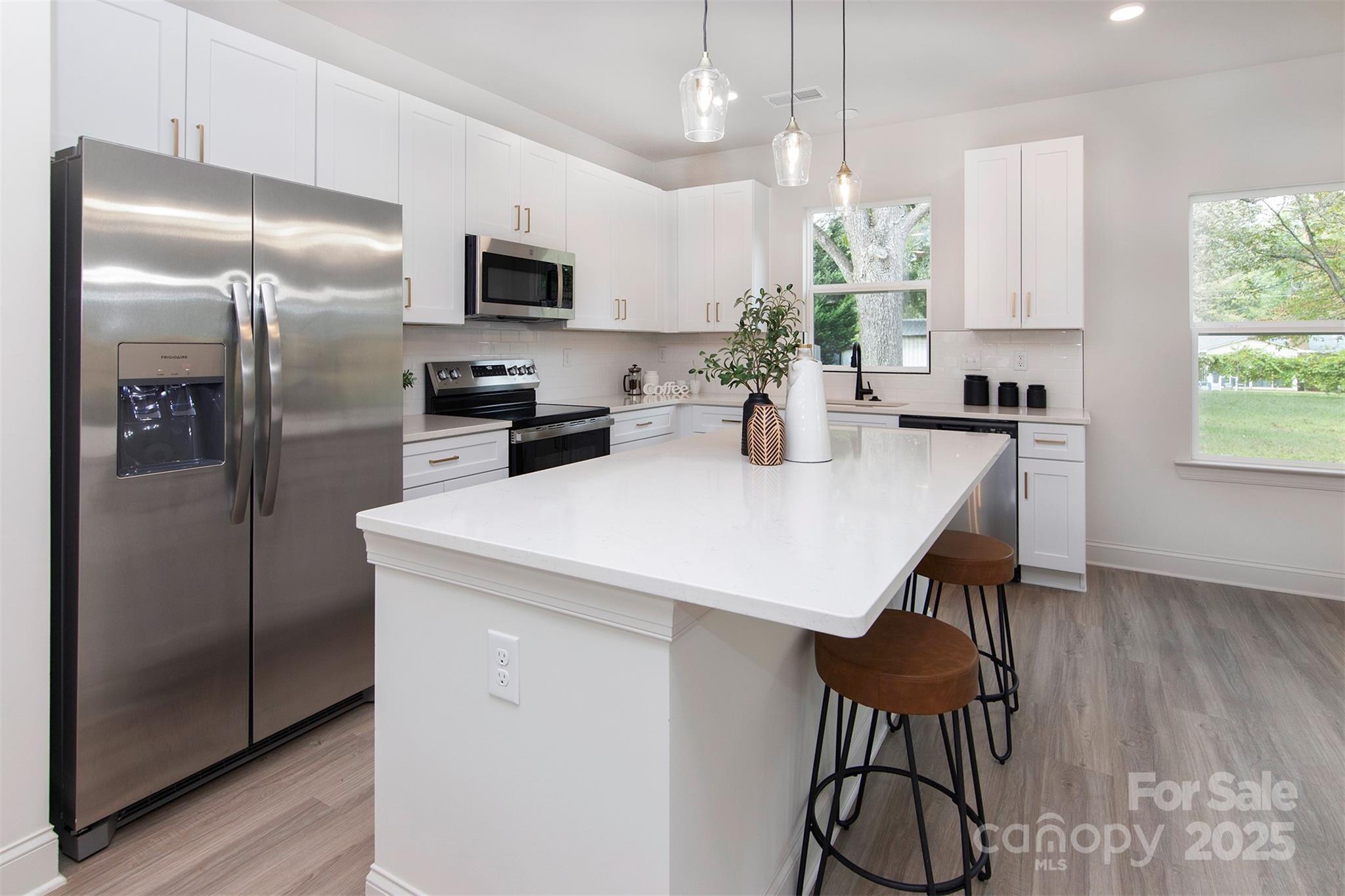 118 Durham Road Stanley, NC 28164 - Photo 8 of 24 a kitchen with kitchen island a large counter top space appliances and cabinets