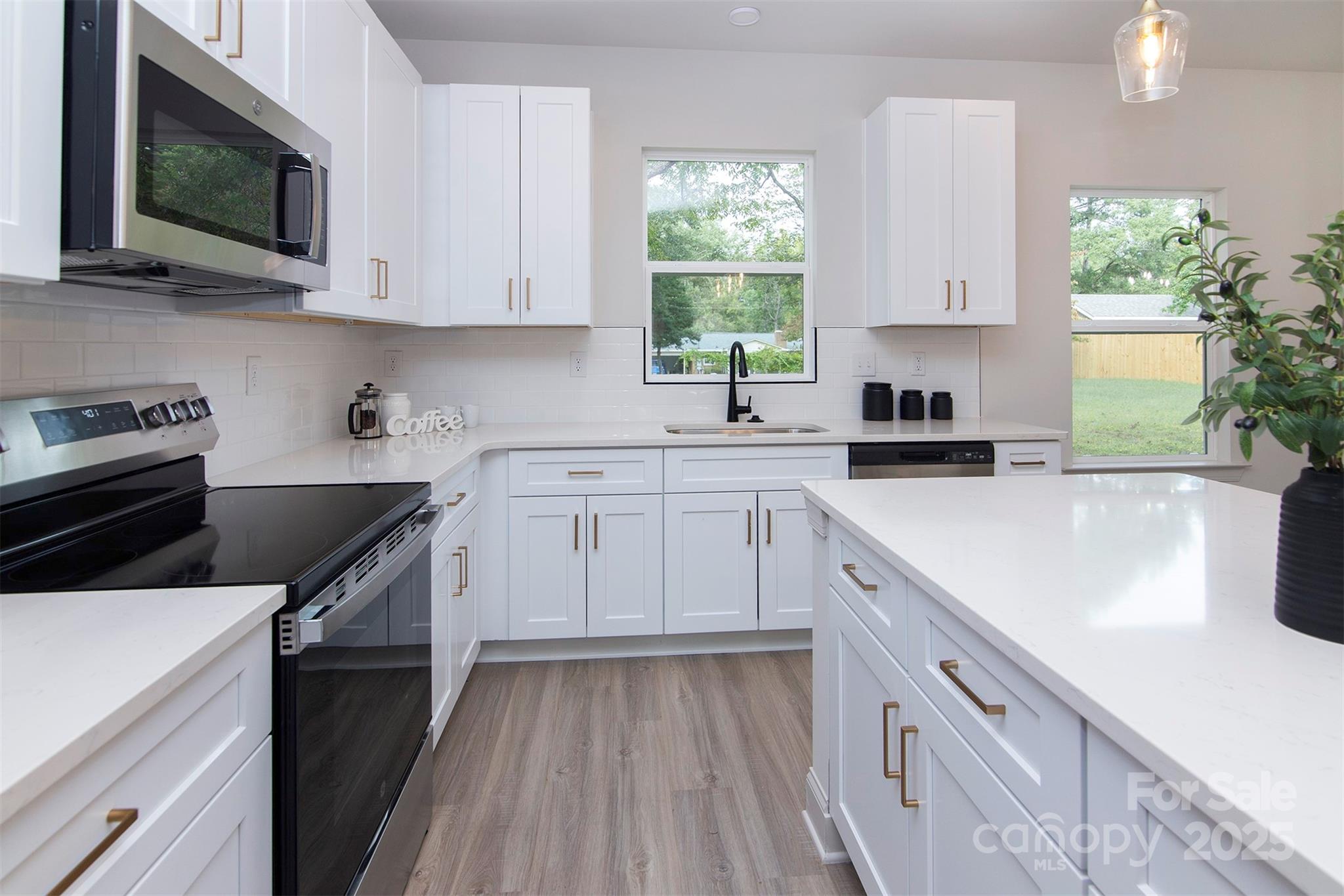 118 Durham Road Stanley, NC 28164 - Photo 10 of 24 a kitchen with a sink stove and microwave