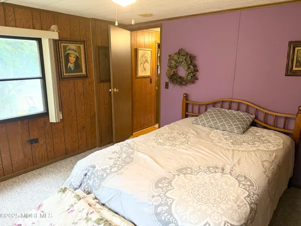 a bedroom with a bed and a mirror