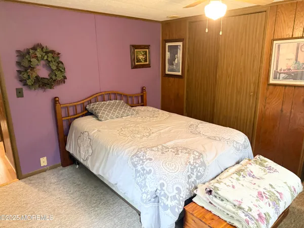 a large bed sitting in a bedroom next to a window