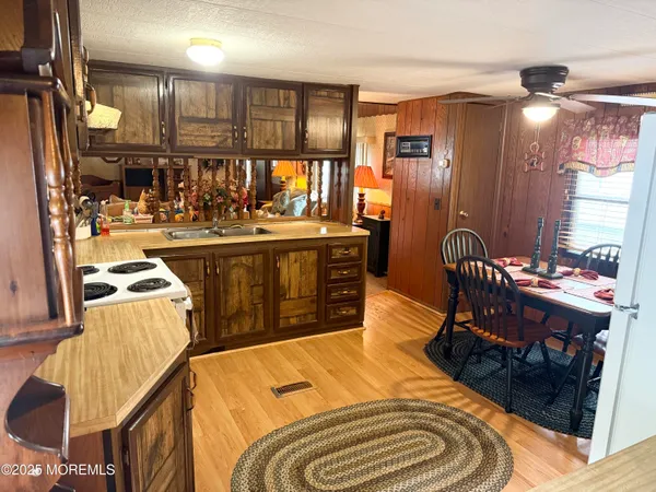 a kitchen with stainless steel appliances granite countertop a sink and a refrigerator
