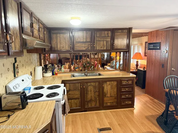 a kitchen with stainless steel appliances granite countertop a sink and cabinets