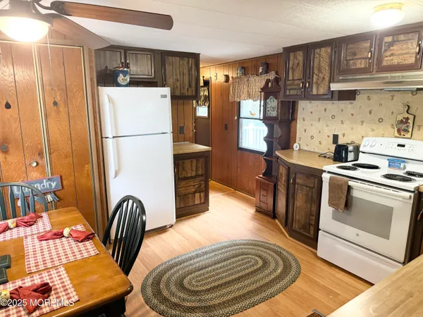 a kitchen with stainless steel appliances granite countertop a refrigerator a stove a sink and a refrigerator