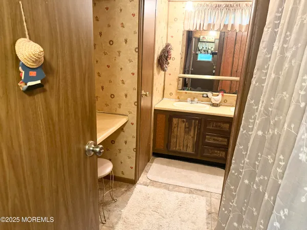 a bathroom with a granite countertop sink and a mirror