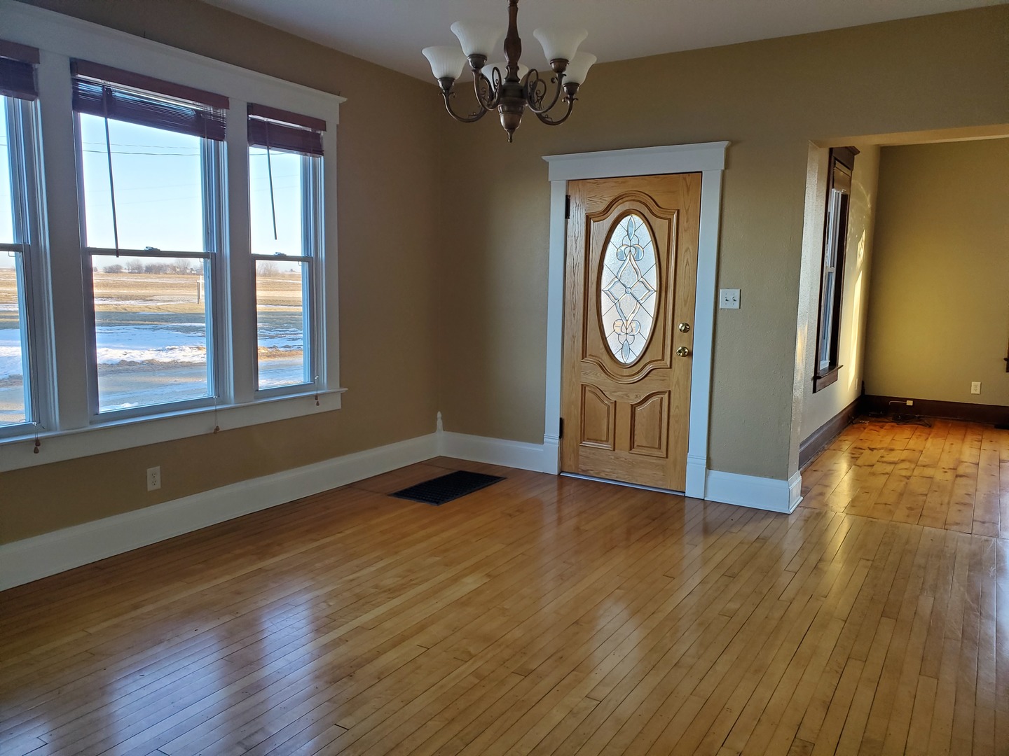 15 North 46th Road Mendota, IL 61342 - Photo 8 of 20 a view of an empty room with wooden floor windows and a chandelier