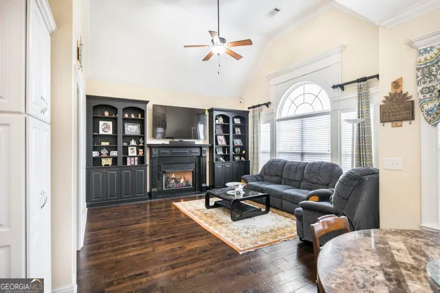 a living room with furniture fireplace and a window