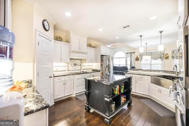 a kitchen with cabinets and chairs